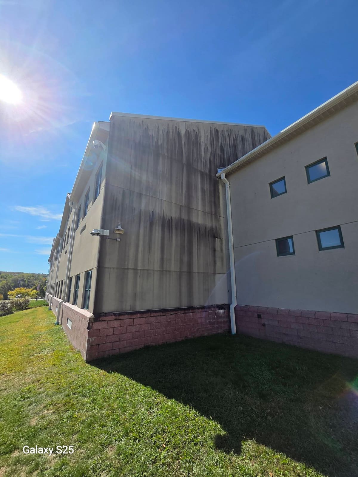 Large commercial building with freshly washed light siding