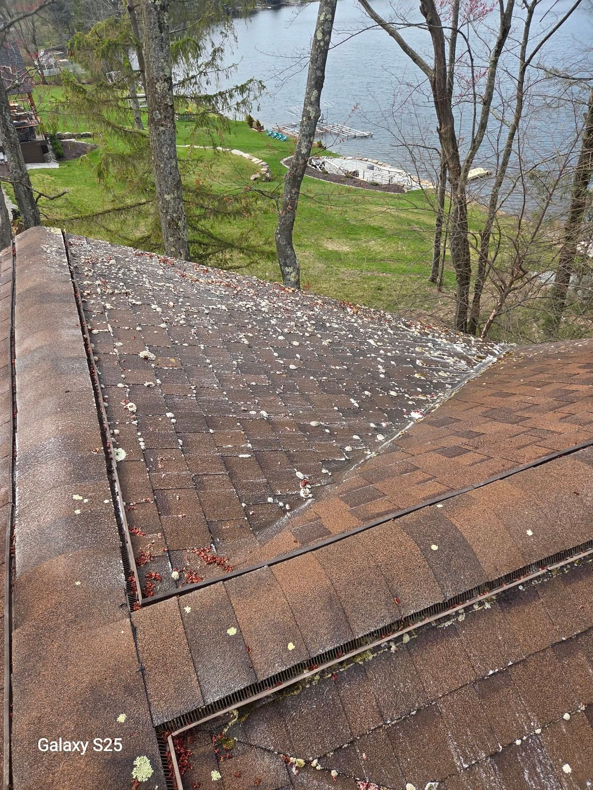Clean brown shingle roof at a lakeside home after soft washing